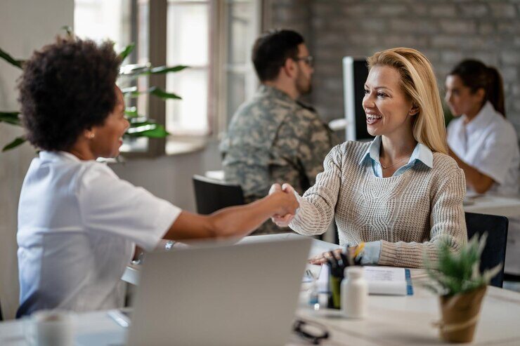 happy-woman-african-american-female-doctor-shaking-hands-after-medical-appointment-clinic_637285-1164