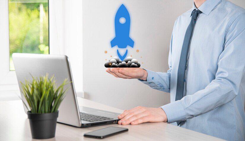 startup-business-concept-businessman-holding-tablet-icon-rocket-is-launching-soar-flying-out-from-screen-with-network-connection-dark-background_150455-11988-1